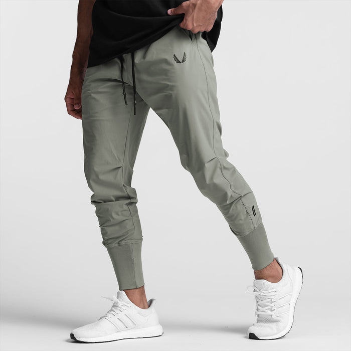 Tetra-Lite High Rib Jogger in sage worn by model with white sneakers, side view