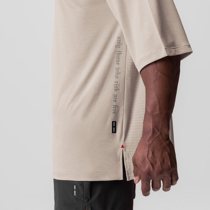 3D-Lite 2.0 3/4-sleeve oversized tee in sand smoke worn by model, side view showing text detail