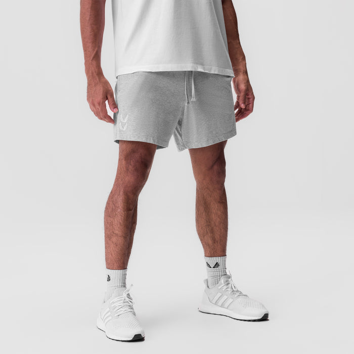 Tech Essential Sweat Short in Heather Grey, modeled with white tee and sneakers