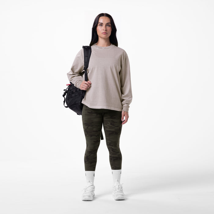 Tech Essential Relaxed Long Sleeve in Faded Chai worn with camo leggings and white socks