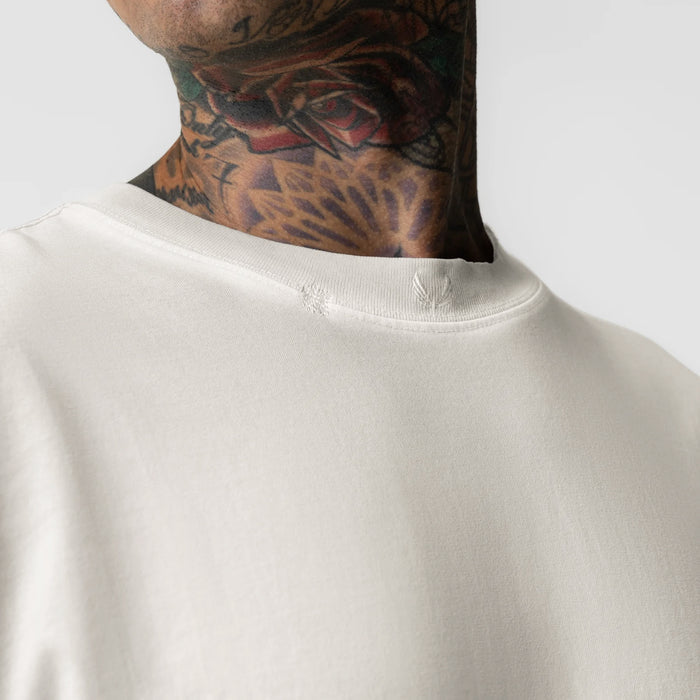 Tech Essential Relaxed Long Sleeve in faded stone, worn by model showing neckline detail