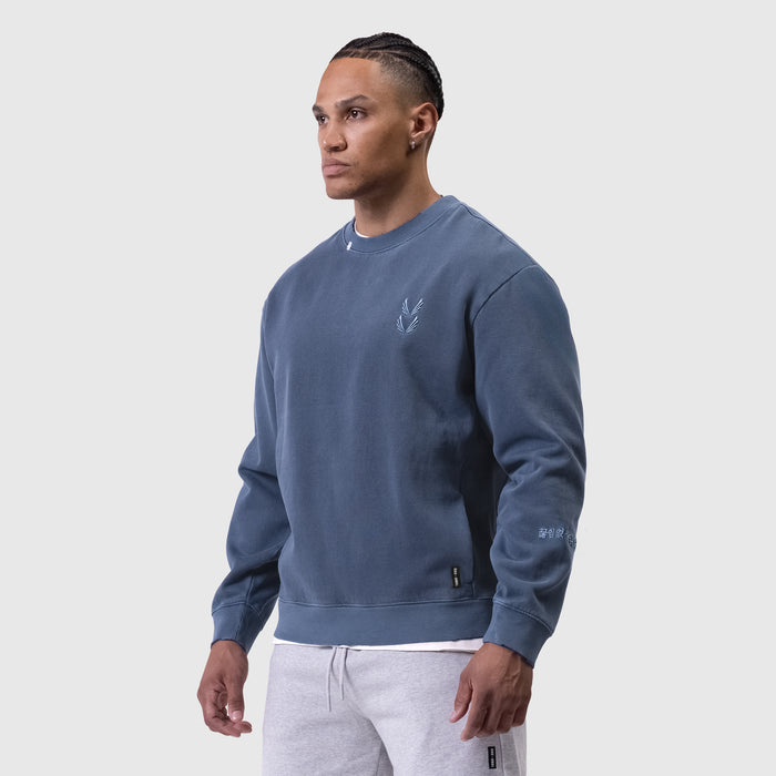 Tech Essential Distressed Crewneck in faded navy, worn by model in side profile