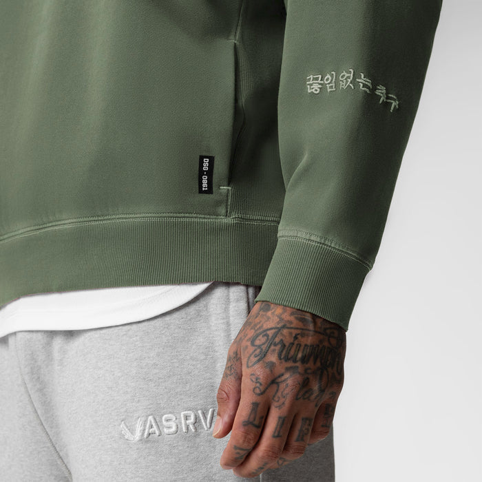 Tech Essential Distressed Crewneck in faded olive worn by model, detail view of sleeve and chest