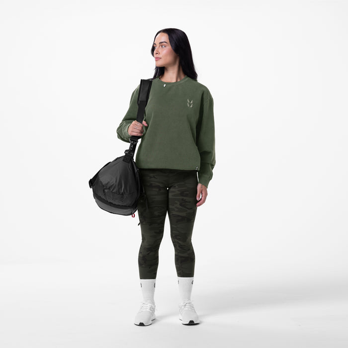 Tech Essential Distressed Crewneck in faded olive worn with camo leggings and white socks, front view