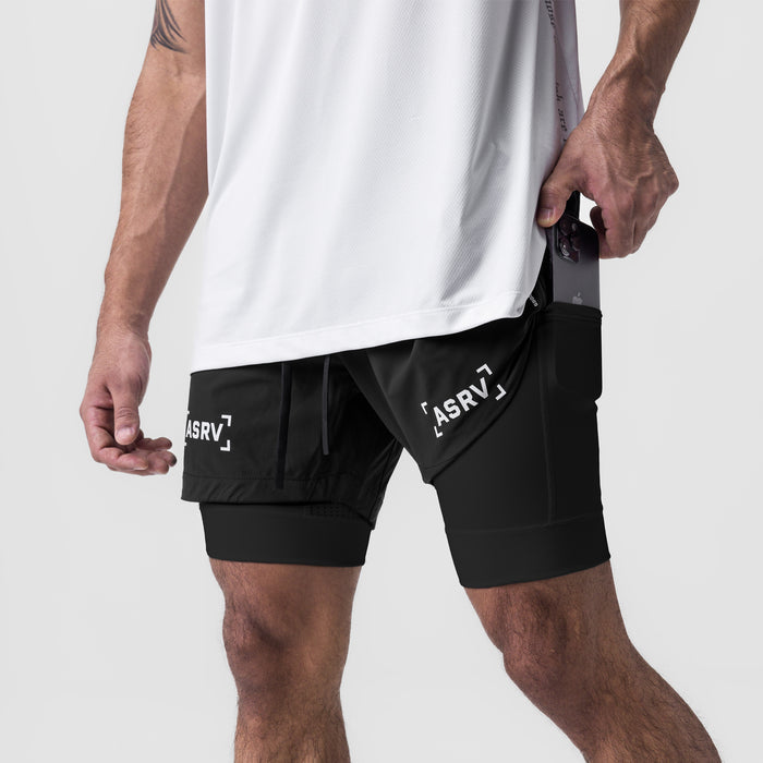 Tetra-Lite 5" Liner Short in black, worn by model with hand in pocket, side view