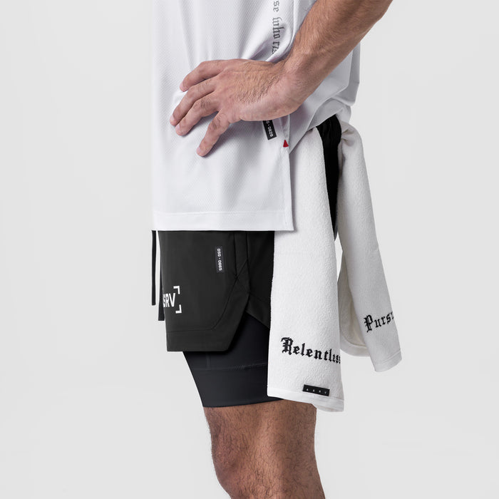 Tetra-Lite 5" Liner Short in black, worn with white tee and towel, side view