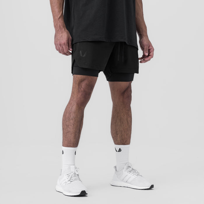 Tetra-Lite 5" Liner Short in black, worn by model with white socks and sneakers, front view