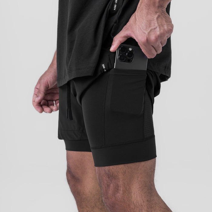 Tetra-Lite 5" Liner Short in black, worn by model holding phone in side pocket