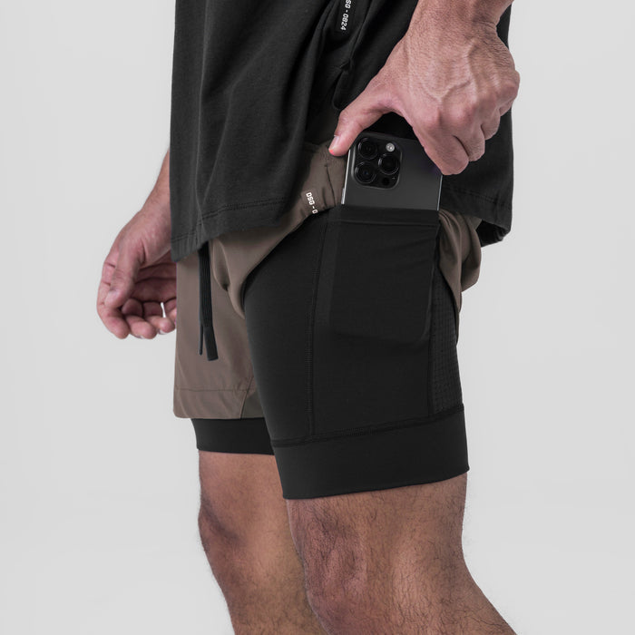 Tetra-Lite 5" Liner Short in Deep Taupe and Black, model holding phone in side pocket