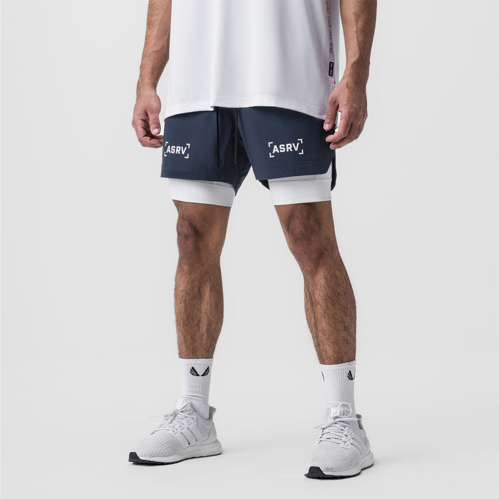 Tetra-Lite 5" Liner Short in navy and white, worn by model with white socks and sneakers