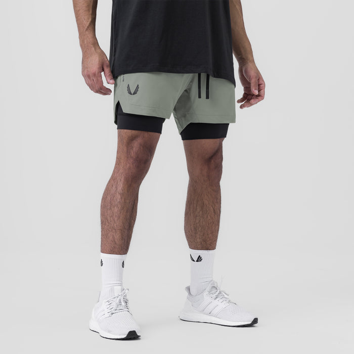 Tetra-Lite 5" Liner Short in Sage and Black, worn with white socks and sneakers