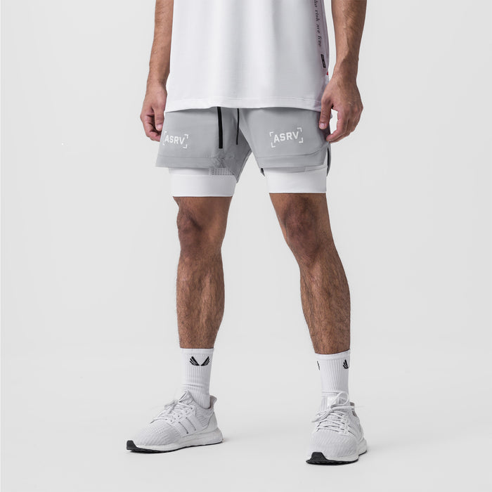 Tetra-Lite 5" Liner Short in slate grey and white, worn by model with white sneakers, front view