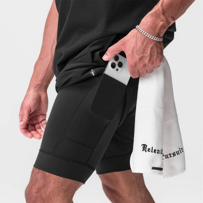 Tetra-Lite 7" Liner Short in black, worn by model holding white iPhone in pocket