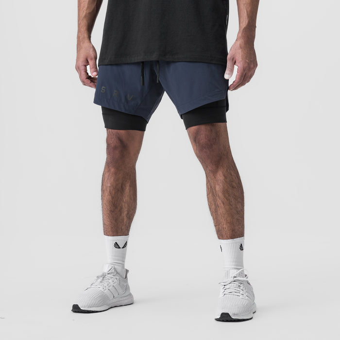 Tetra-Lite 7" Liner Short in Navy and Black worn with white sneakers, front view