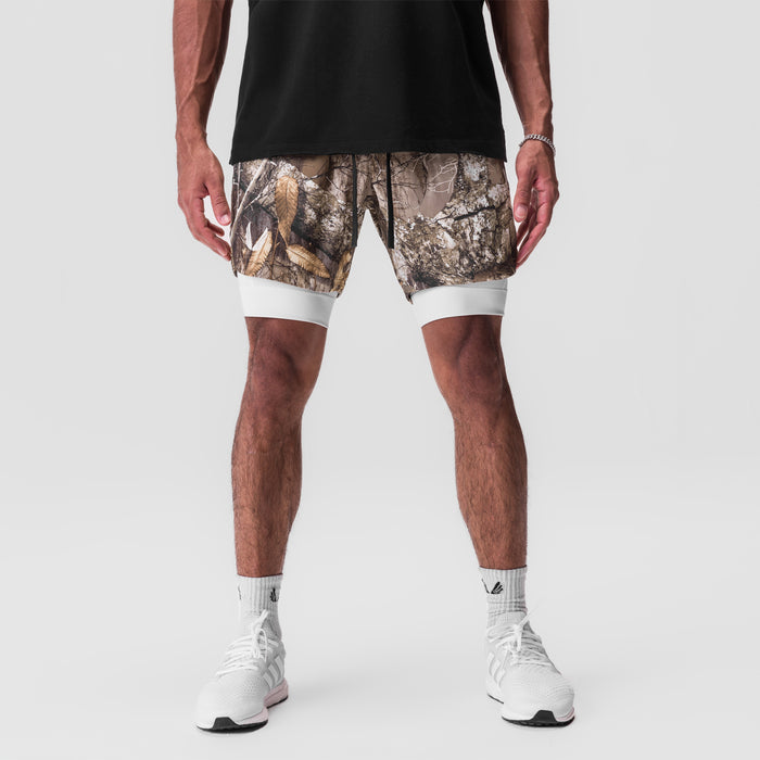 Tetra-Lite 7" Liner Short in Realtree Camo with white accents, worn by model with white socks and sneakers