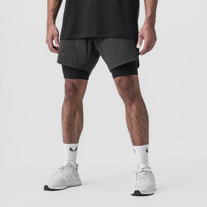 Tetra-Lite 7" Liner Short in Space Grey and Black, modeled from waist down with white sneakers