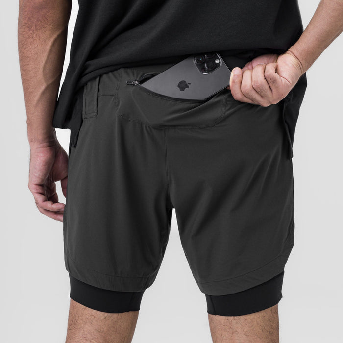 Tetra-Lite 7" Liner Short in Space Grey and Black, model holding phone in front pocket