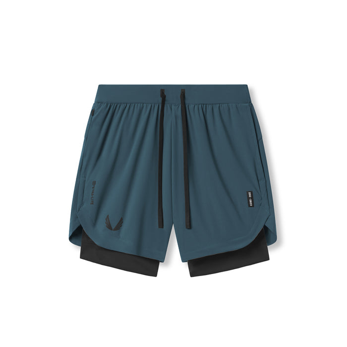 Flatlay of Tetra-Lite 7" Liner Shorts in Storm blue and black, front view