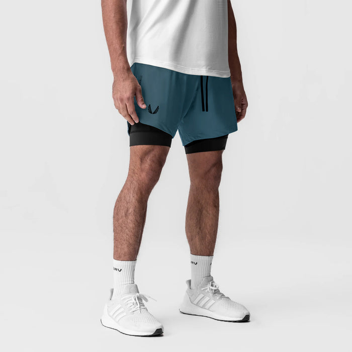 Tetra-Lite 7" Liner Short in Storm/Black worn with white socks and sneakers, front view