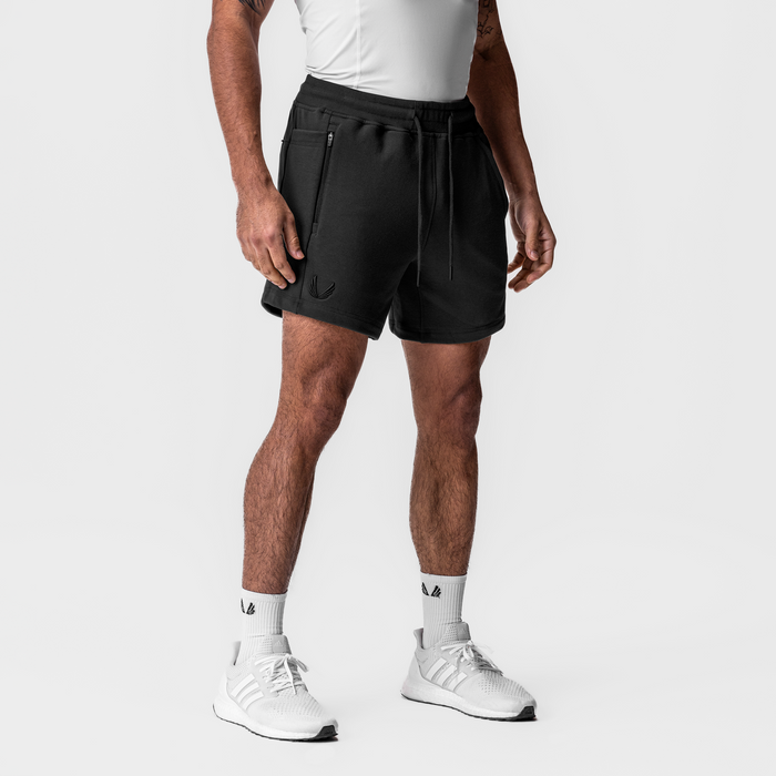 Black Tech-Terry Sidelock Sweat Shorts on model, front view with white sneakers