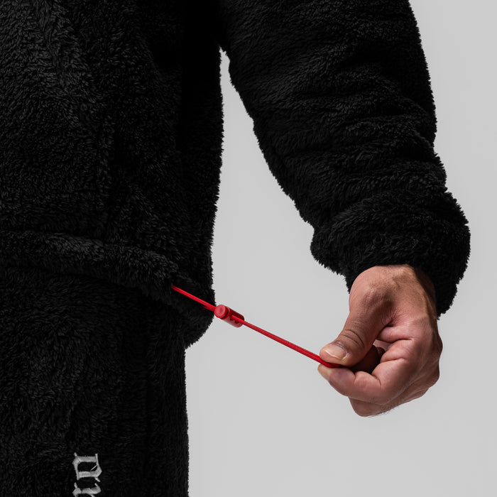 Black Sherpa Recovery Full Zip Hoodie worn by model holding red cord detail