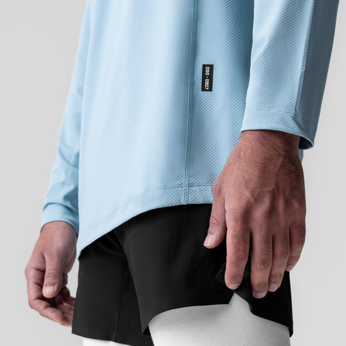 AeroSilver Training Long Sleeve in light sky worn by model, closeup of torso and sleeves