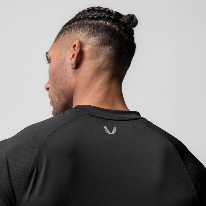 AeroSilver Fitted Tee in black worn by model, back view showing logo