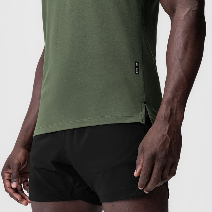 Supima Fitted Tee in olive green worn with black shorts, side view on model