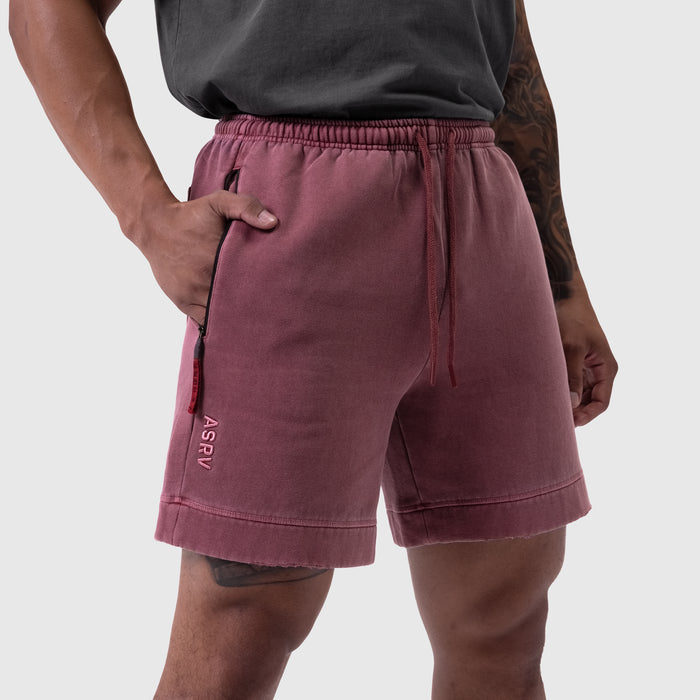 Tech Essential Sweat Short in faded crimson worn by model, side view