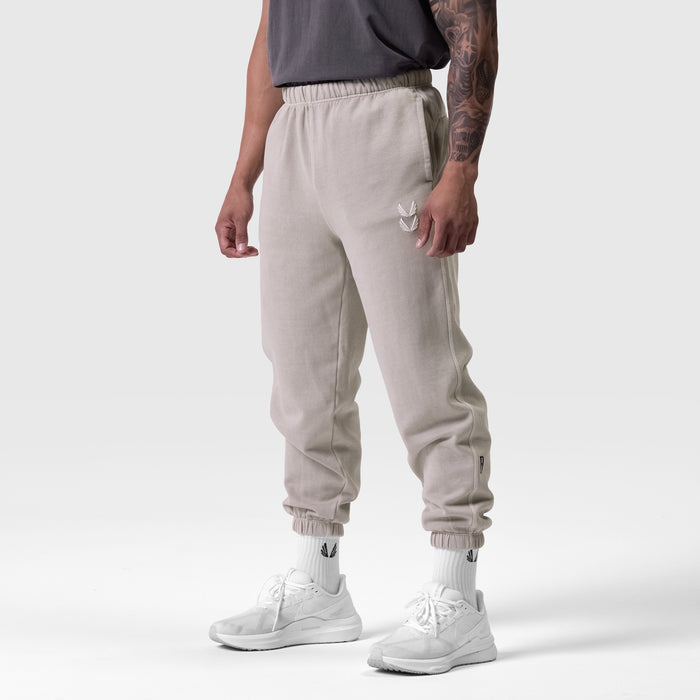 Tech Essential Sweats in faded chai worn by model, side view with white sneakers