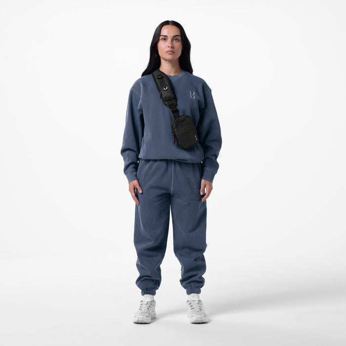 Tech Essential™ Sweats in faded navy, worn with black shoulder bag and white sneakers
