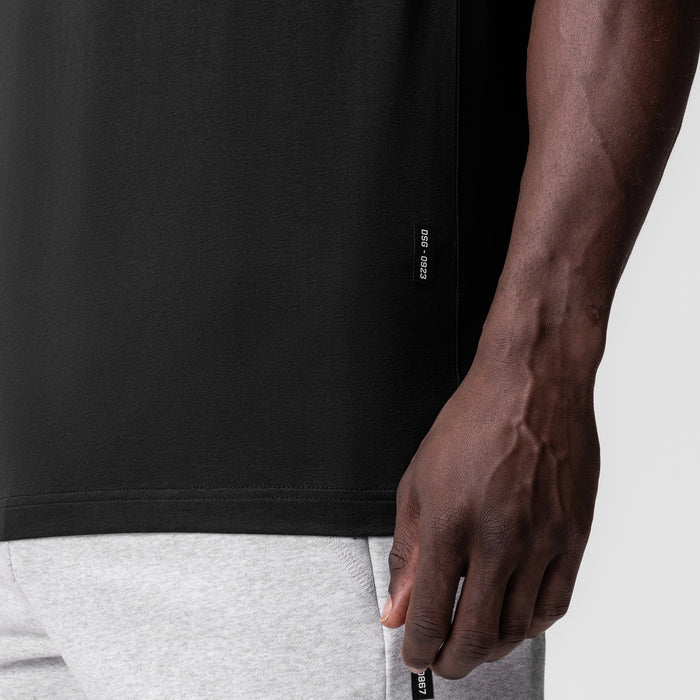 Black Supima Essential Tee worn by model, side detail view showing fit and fabric