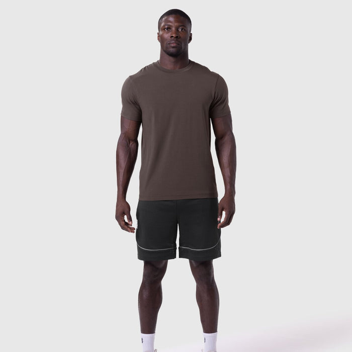 Supima Essential Tee in Dark Earth worn with black shorts, front view on model