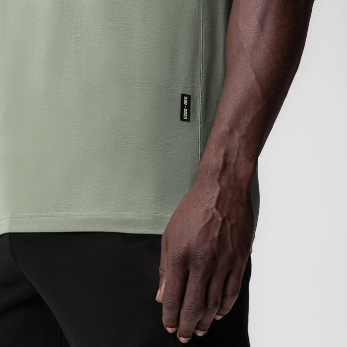 Supima Essential Tee in sage worn by model, side view detail