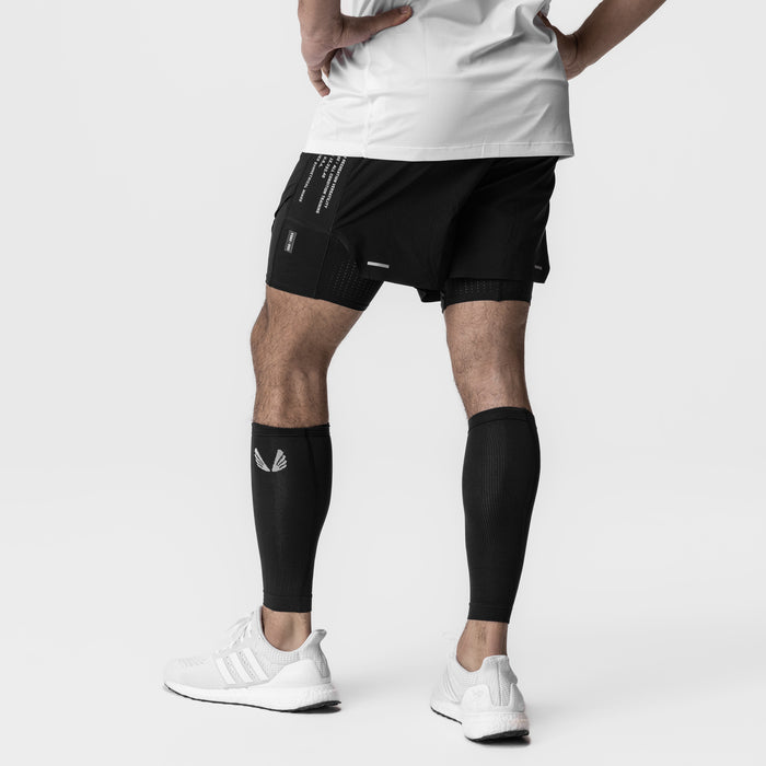 Body-Mapped Calf Sleeve in black, worn on model's leg during athletic pose