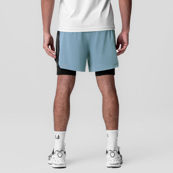 Aerotex Hybrid Liner Short in light sky blue and black, worn by model, back view