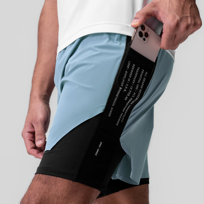 Aerotex™ Hybrid Liner Short in Light Sky/Black, model holding phone in side pocket