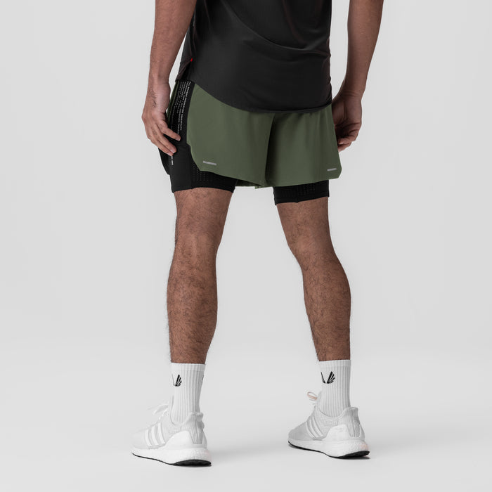 Aerotex Hybrid Liner Short in olive and black, worn by model, back view