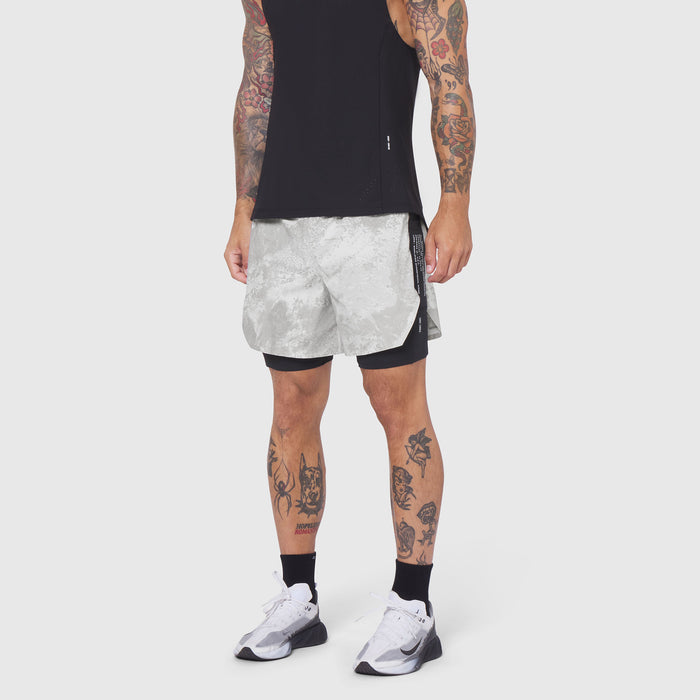 Aerotex Hybrid Liner Short in white camo with black liner, worn by model with tattoos