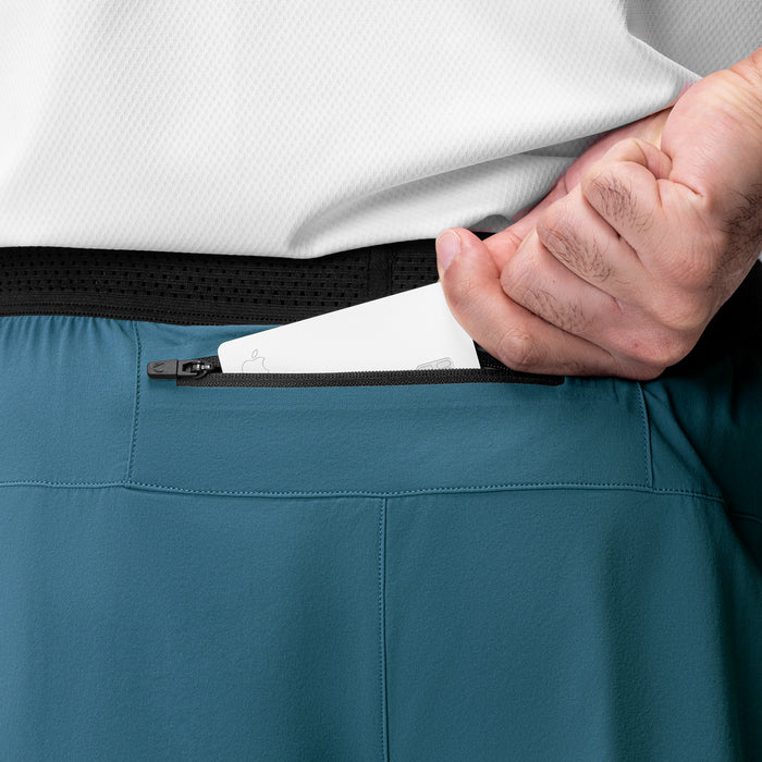 Aerotex Hybrid Liner Short in Storm/Black, model demonstrating zippered pocket detail