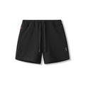 flatlay of black waffle knit sweat shorts on white background, front view