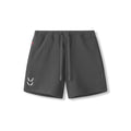 Flatlay of waffle knit sweat shorts in space grey with drawstring and logo detail