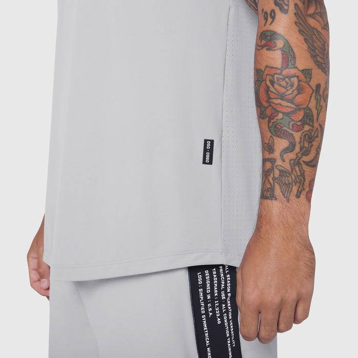 Laser-Vent™ Tank Top in white, worn by model showing side view with tattooed arm visible