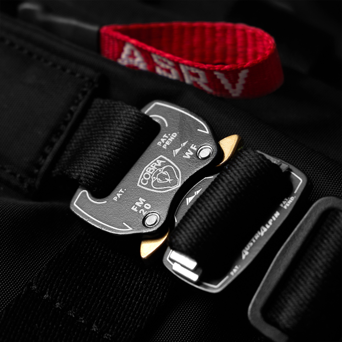 Flatlay of 0961 Waterproof MOLLE Backpack in black with tactical gear and red strap