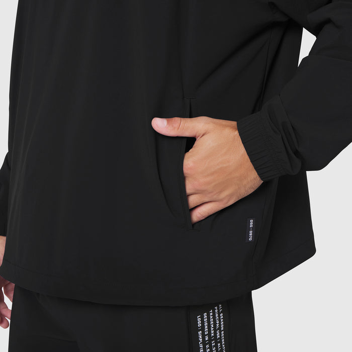 Black Aerotex Quarter-Zip Jacket worn by model with hand in pocket, front detail view
