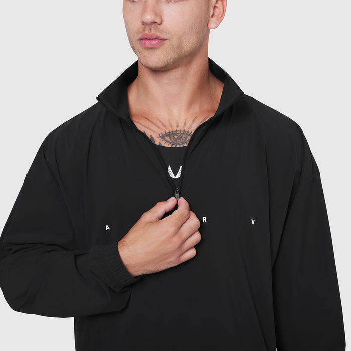 Black Aerotex Quarter-Zip Jacket worn by male model, front view with hand on zipper