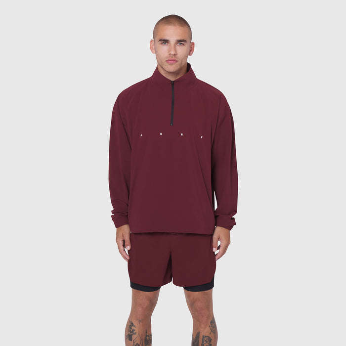 Aerotex Quarter-Zip Jacket in crimson worn with matching shorts, front view on model