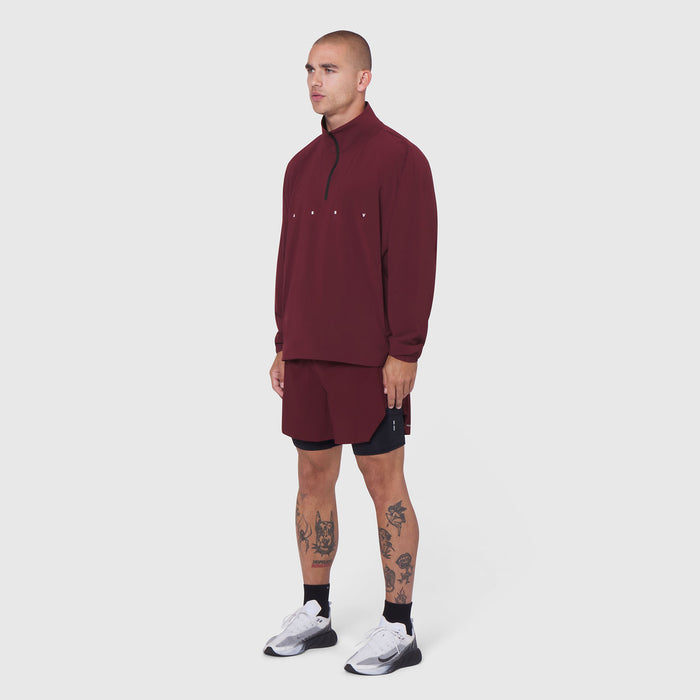 Aerotex Quarter-Zip Jacket in crimson worn by model with matching shorts, side view