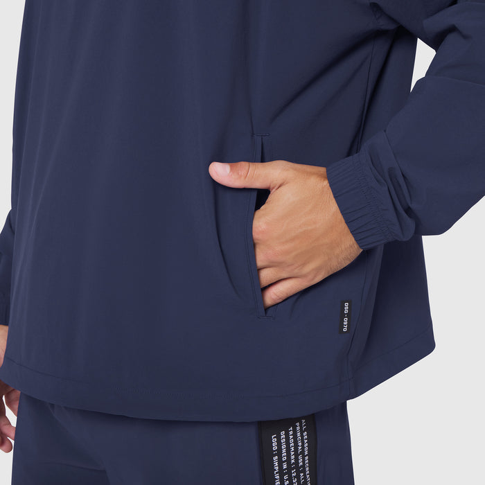 Aerotex Quarter-Zip Jacket in navy, worn by model with hand in pocket, front view