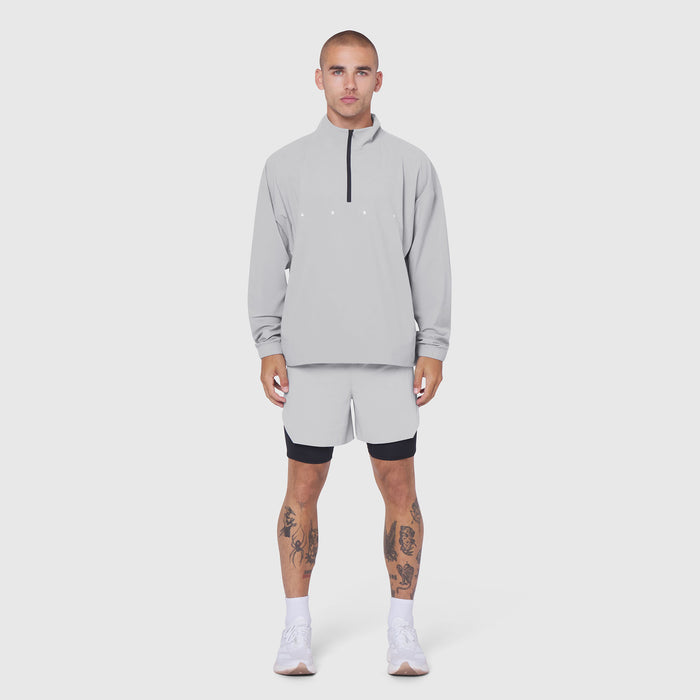 Aerotex Quarter-Zip Jacket in slate grey worn with matching shorts, front view on model